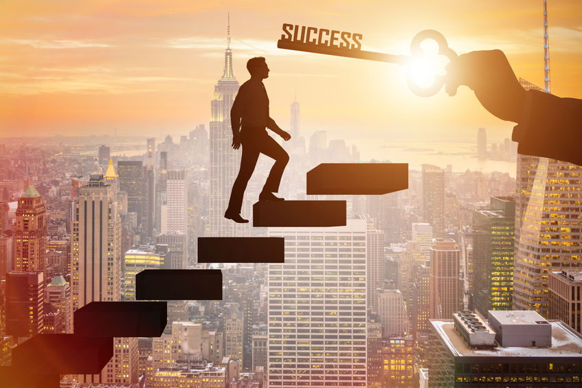 Businessman climbing the career ladder of success